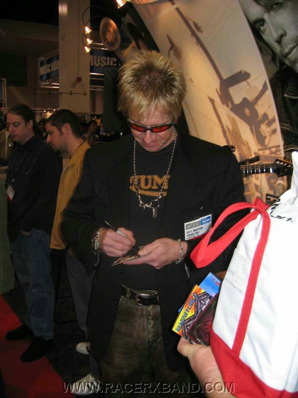 29. Jeff signing stuff in front of Ibanez..jpg